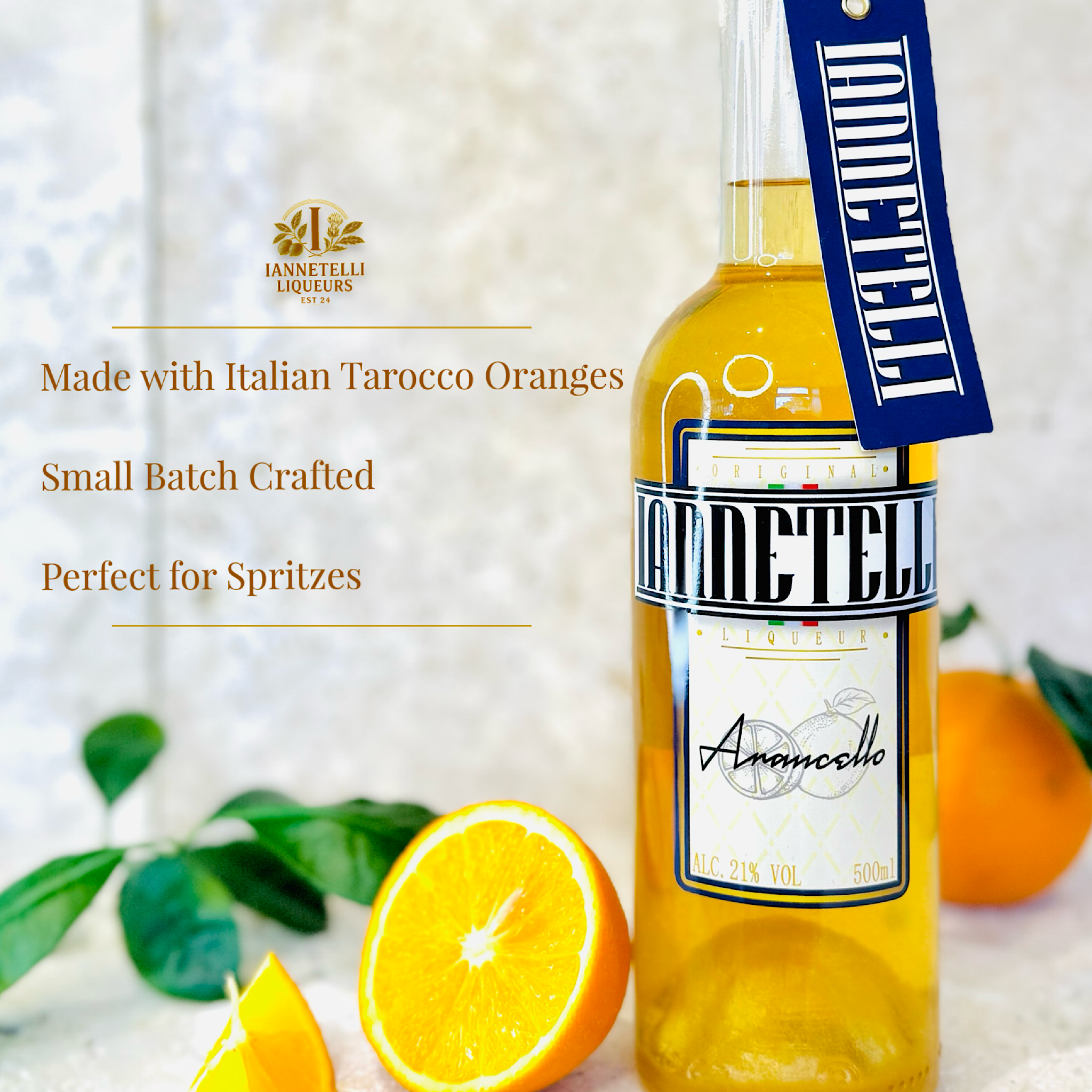 Iannetelli Arancello bottle with sliced oranges and green leaves on a light background
