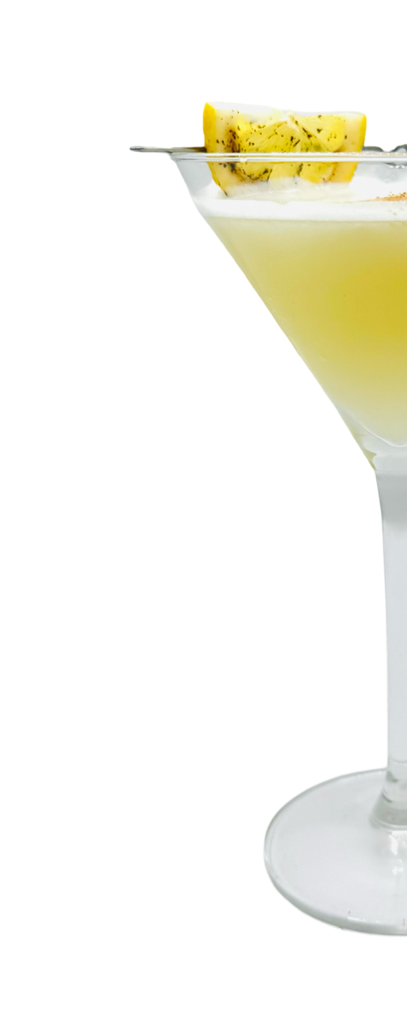 Lustro d’Oro cocktail served in a martini glass with a frothy top and garnished with a pineapple slice